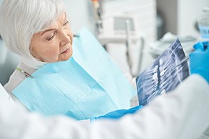 a dentist showing a patient her X-rays