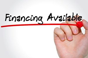 a hand writing financing available on glass and underlining it in red marker