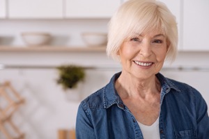 Older woman with dental implants in Dallas, TX in kitchen