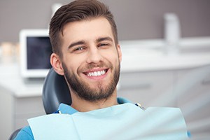 Male dental patient with dental implants in Dallas, TX smiling at dentist’s office