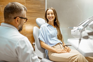 Woman smiling while talking to Dallas dentist about braces