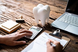 Patient calculating cost of traditional braces in Dallas