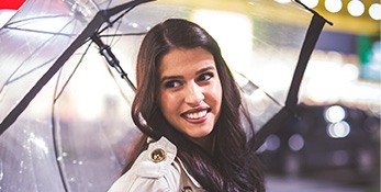 Smiling woman under umbrella