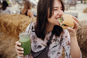 happy person eating a sandwich