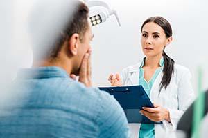 Emergency dentist in Dallas examining a patient