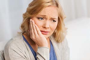 Woman concerned about the cost of dental emergencies