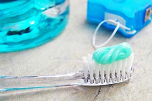 Closeup of toothbrush and toothpaste for preventing dental emergencies