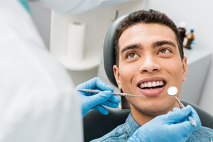 a man smiling and talking to his dentist