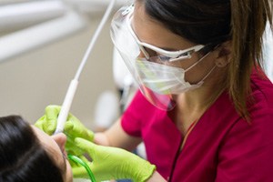 a dentist completing a deep cleaning on a patient