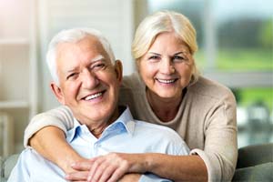 older couple smiling after getting dental implants in Dallas
