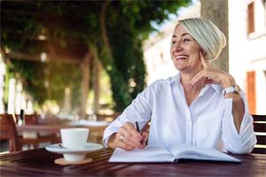 older woman smiling after getting dental implants in Dallas