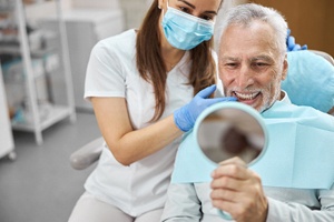 man smiling after getting dental implants in Dallas