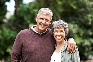 smiling senior man and woman with implant dentures in Dallas 