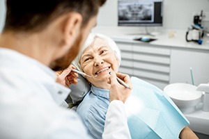 dentist examining a senior woman’s mouth