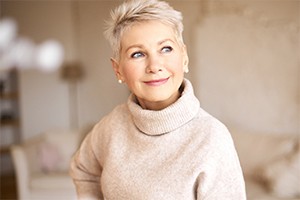 An older woman with dental implants in Dallas smiling