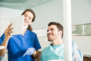 Patient smiling with an implant dentist in Dallas