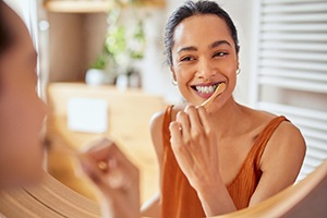 a woman brushing her teeth