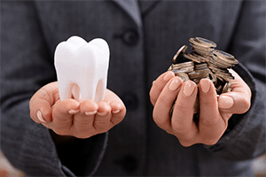 Hands holding molar and coins