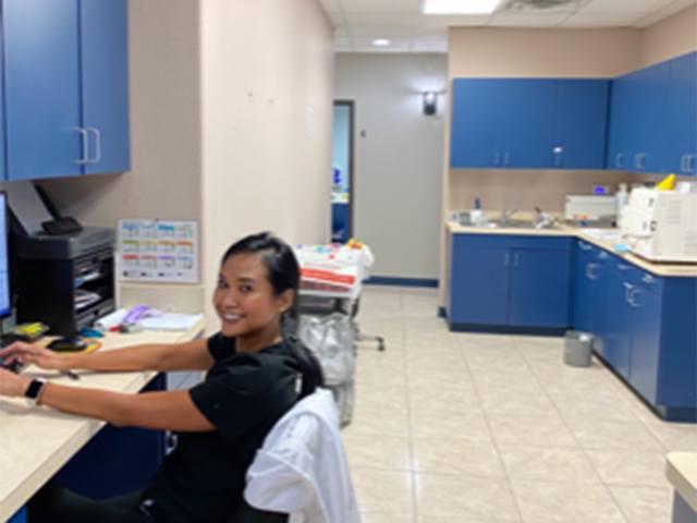staff working in dental office backroom with equipment