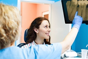 Dentist and patient looking at dental x-rays