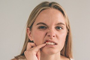 Woman looking at gums in mirror