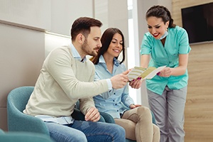 a dental assistant talking to patients about financing