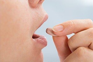 Patient taking an oral sedative pill