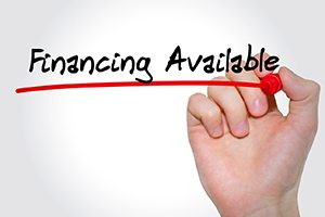 a person with a red marker underlining “financing available”
