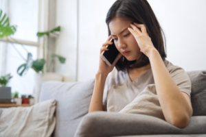 stressed person talking on the phone with their emergency dentist in Dallas 