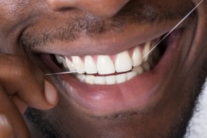 an up-close view of a person flossing their teeth