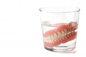 dentures in a glass of water