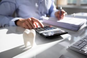 a person calculating the cost of dentures