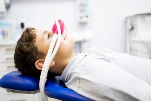 a child with a nitrous oxide mask on