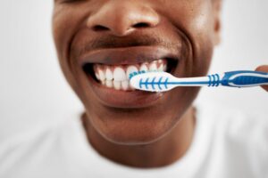 a man brushing his teeth too hard