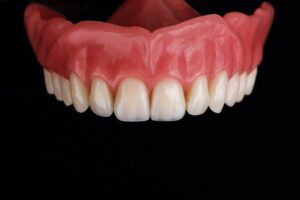 a denture against a black background