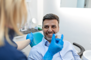 a dentist showing a patient clear aligners