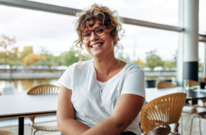 a woman sitting in a chair and smiling